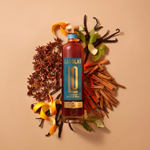 Las Olas Premium Spiced Rum on a background that features its spice Ingredients